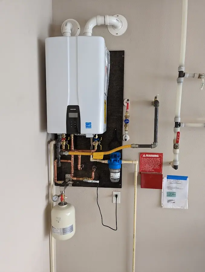 Professional plumber installing copper piping in a Sylvan home